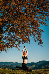 Meditation. Woman balanced, practicing meditation and zen energy yoga in mountains. Girl doing fitness exercise sport outdoors in morning. Healthy lifestyle concept. Sunrise.