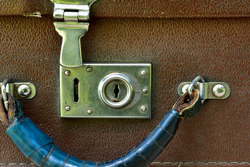 open lock and handle of an old suitcase front view