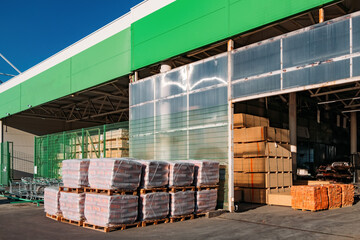 Stacked packages with construction materials near the warehouse