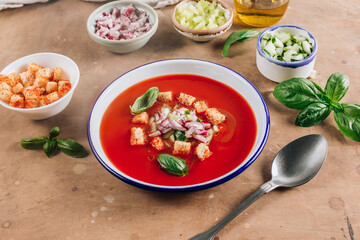 Spanish summer cold soup gazpacho with vegetables on beige rustic background.