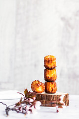 Selective focus to canelé cake - a small french pastry flavored with rum and vanilla on the table.