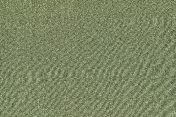 The texture of natural cotton knitted fabric is green, like grass, color. Soft cotton simple fabric in green color. Abstract background.