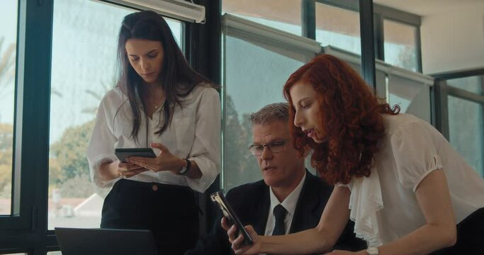 A young businesswoman taking a picture of something from a computer during a business meeting. Slow motion. 
