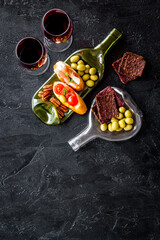 Toasts with prosciutto and tomatoes with red wine top view space for tex