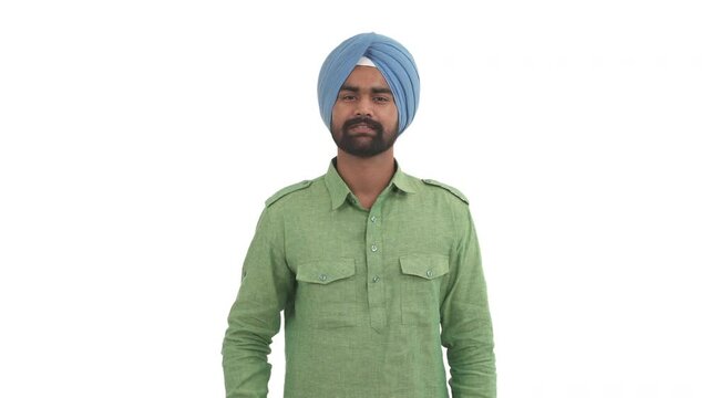 Young beard Indian man sending air kiss on camera. Isolated on white background