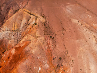 Aerial drone view of colorful eroded landform of Altai mountains with yellow, brown and red colors. Nature landscape in popular tourist location called Mars, near the border with Mongolia, Chagan-Uzun