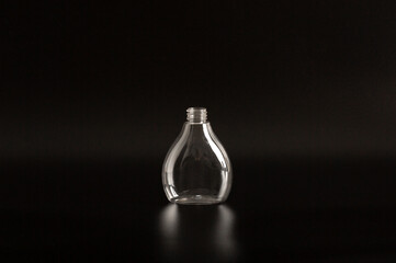 Clean white and transparent plastic container of different sizes on a black background. Packaging, bottle for cosmetics, antiseptics, detergents and chemical cleaning products for medical and cosmetic
