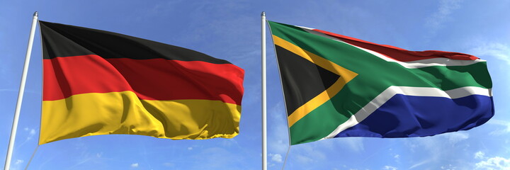 Flying flags of Germany and South africa on high flagpoles. 3d rendering