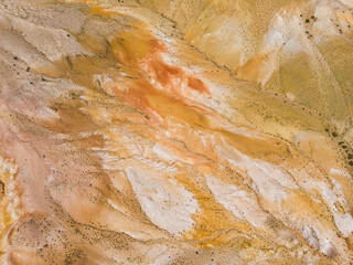 Aerial drone view of colorful eroded landform of Altai mountains with yellow, brown and red colors. Nature landscape in popular tourist location called Mars, near the border with Mongolia, Chagan-Uzun