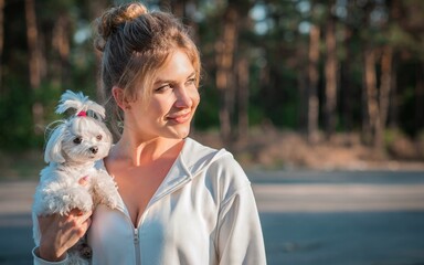 Woman with a Little fashionable luxury lapdog dog at walk, pet lifestyle