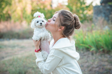 Woman with a Little fashionable luxury lapdog dog at walk, pet lifestyle