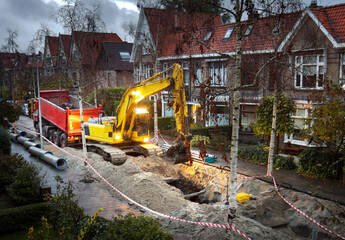 Early morning sewerage works in a residential area  - obrazy, fototapety, plakaty