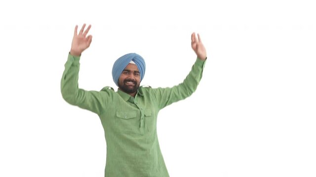Satisfied Indian beard man raising up hands, making OK sign, lifting shoulders up and putting its down in dancing moves. Isolated on white background