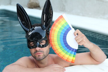 Handsome bunny holding rainbow flag