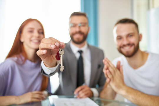close-up photo of keys, realtor giving key from apartment to owners, new flat, house, real estate services concept