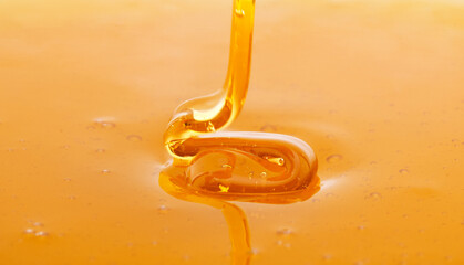 Macro of thick fresh honey dripping