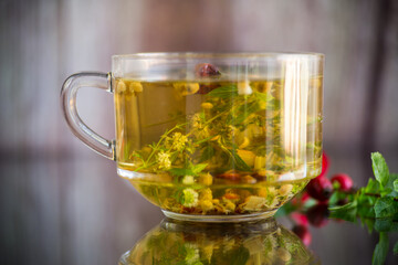 natural hot tea from various summer herbs in a glass cup