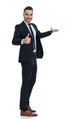 Side view of smiling businessman gesturing ok and presenting