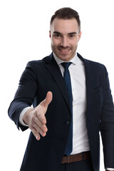 Happy businessman reaching for a hand shake and laughing