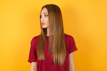 Close up side profile photo Beautiful Young beautiful caucasian girl wearing red t-shirt over...