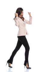 Celebrating businesswoman shouting with fists clenched