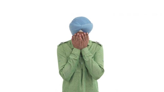 Depressed Indian man covering his face by both hands because of disappointed about something. Isolated on white background