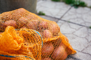 Bag with potatoes in it outdoors.