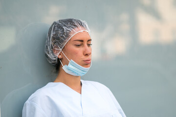 Portrait of a doctor woman with a tired expression taking a break and resting
