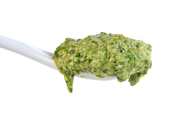 Green sauce on the ceramic bowl isolated on white background. Adjika