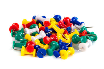 Closeup of Many Colored Thumbtacks on White
