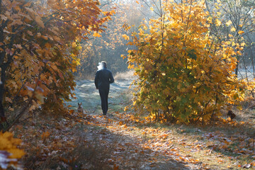 man smoker with dog on a walk in autumn