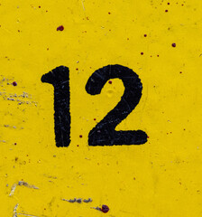 The number 12 is black on a yellow background. Grunge style, scratches and scuffs