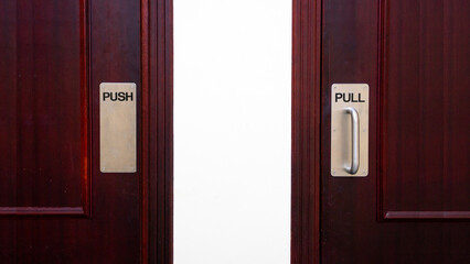 Push and pull sign on a wooden door 