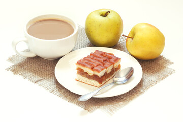 Sweet apple jam pie and hot cacao drink on rustic style napkin.