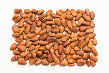 Natural background from pine nuts in brown shell. .