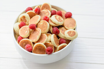 Delicious freshly cooked Homemade Mini Pancake with raspberries. Trendy food. Top view. breakfast food for kids.