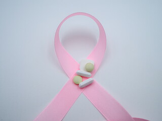 Breat cancer pink ribbon symbol kept on Tablets and pills,OLYMPUS DIGITAL CAMERA