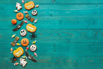 Fresh halloween gingerbread cookies on green wooden table Funny delicious ginger biscuits for Halloween horizontal top view
