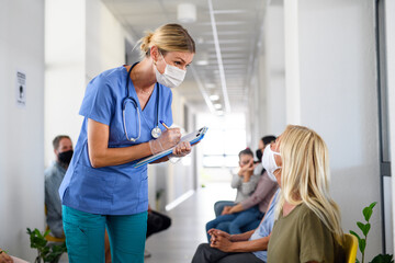 Portrait of nurse with face masks talking to patients, coronavirus, covid-19 and vaccination...