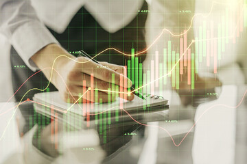 Fototapeta premium Multi exposure of abstract creative financial graph with hand writing in notepad on background, forex and investment concept