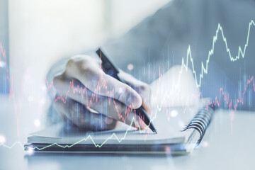 Multi exposure of abstract creative financial chart with hand writing in diary on background, research and analytics concept