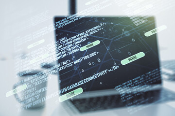 Double exposure of abstract programming language on laptop background, research and development concept