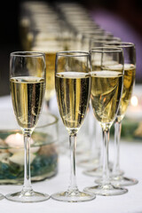 Glasses of champagne on a white table. Celebration event. 