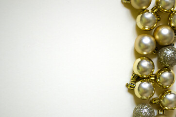 Christmas banner with gold christmas balls on light yellow background. Copyspace. New year flatlay