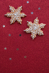 Fototapeta na wymiar Christmas baking lies on a red background. Christmas gingerbread snowflakes lie for the gala dinner