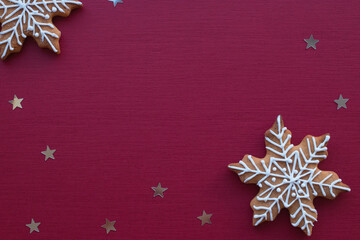 Christmas baking lies on a red background. Christmas gingerbread snowflakes lie for the gala dinner