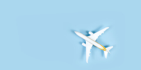 model of passenger airplane on blue background. Flat lay travel concept design. Copy space