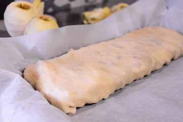 close up of a strudel in a baking tray about to be put in the oven