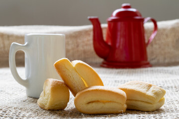 wheat flour biscuit, known as cangalhinha or cangalha, used in the Paraíba do Sul valley for coffee in the houses of the Divino festival. white cup and red teapot.