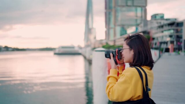 Asian woman tourist take pictures warships at Daring Harbor Sydney , Australia